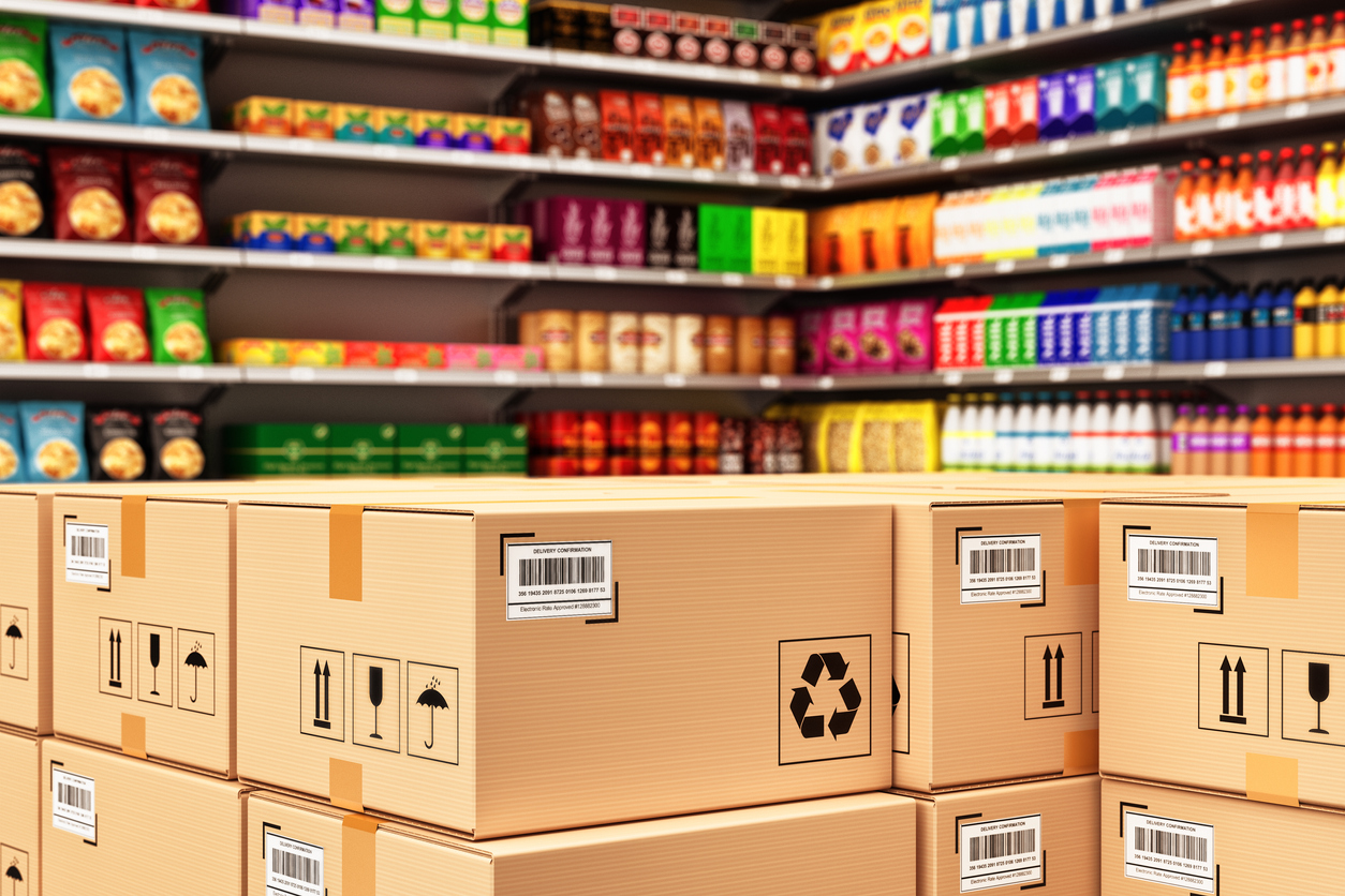 Stack of cardboard boxes in a retail store on the background of shelves with goods